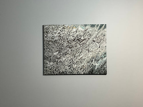 Abstract black and white painting on a gray wall