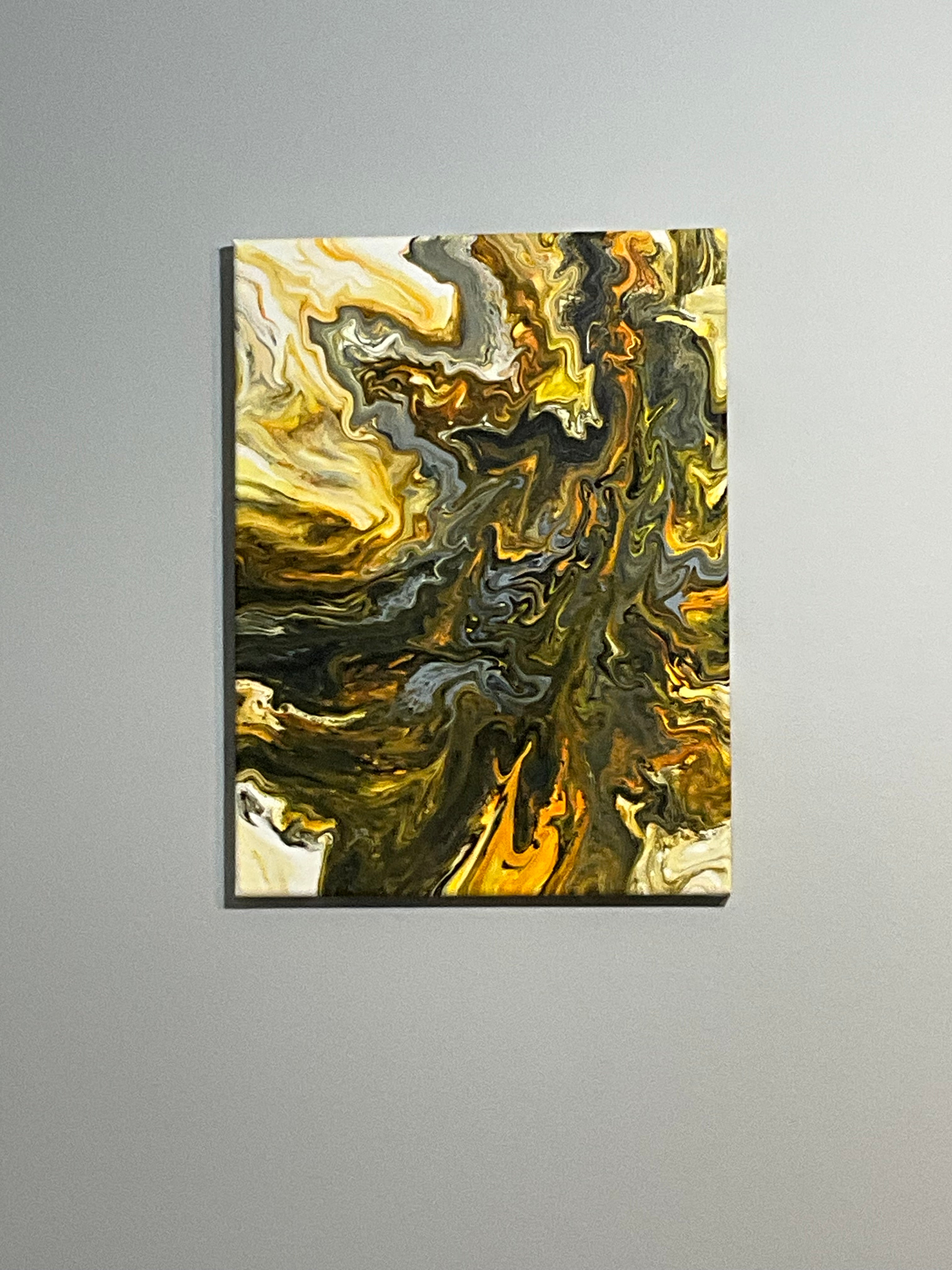 Abstract art piece with gold and black colors on a gray background